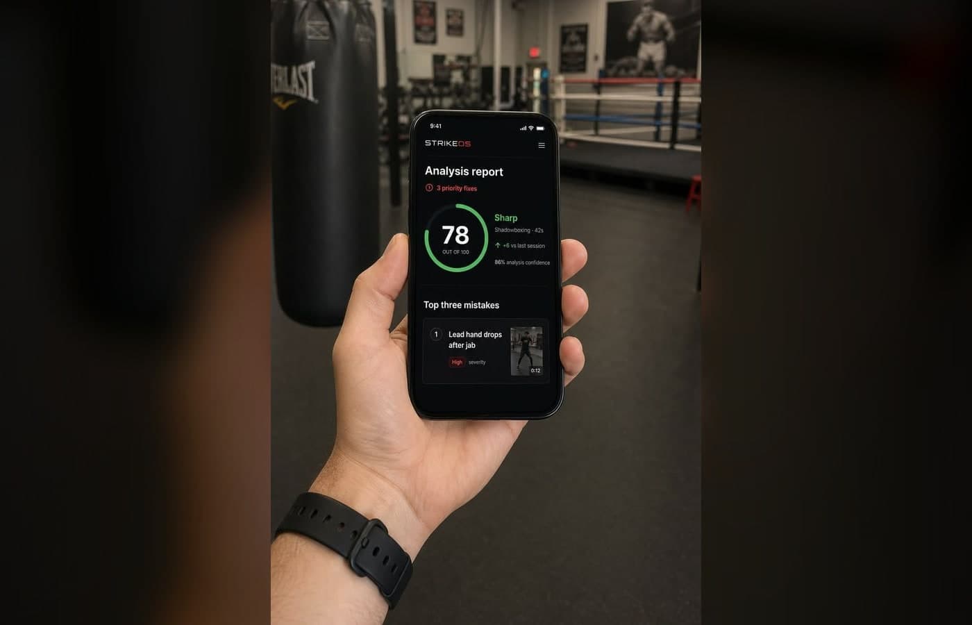 Hand holding a phone showing the StrikeOS Analysis report screen